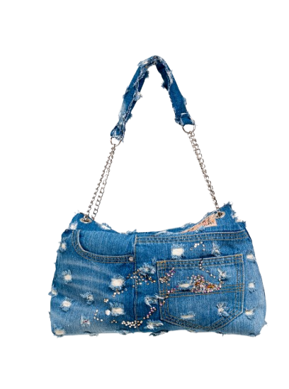 Denim handbag with embellishments on a white background