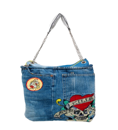 Denim handbag with patches and designs on a white background